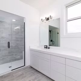 The New Shaker bathroom from Lafata Cabinets uses maple wood with a white finish. Cabinets crafted in Michigan since 1958.
