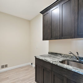 The New Shaker Laundry Room from Lafata Cabinets uses maple wood with a java finish. Cabinets crafted in Michigan since 1958.