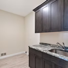 The New Shaker Laundry Room from Lafata Cabinets uses maple wood with a java finish. Cabinets crafted in Michigan since 1958.