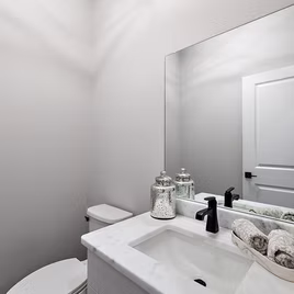 The New Shaker bathroom from Lafata Cabinets uses maple wood with a white finish. Cabinets crafted in Michigan since 1958.
