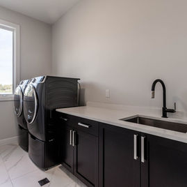 The Shaker Laundry Room from Lafata Cabinets uses maple wood with a graphite finish. Cabinets crafted in Michigan since 1958.