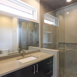 The Midwest bathroom from Lafata Cabinets uses maple wood with a graphite finish. Cabinets crafted in Michigan since 1958.
