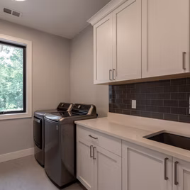 The Shaker Laundry Room from Lafata Cabinets uses maple wood with a white finish. Cabinets crafted in Michigan since 1958.