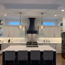 The Jamestown Kitchen V from LaFata Kitchen has Maple wood on both the perimeter and the island. There is custom paint for the island finish and white for the perimeter. Cabinets crafted in Michigan since 1958.