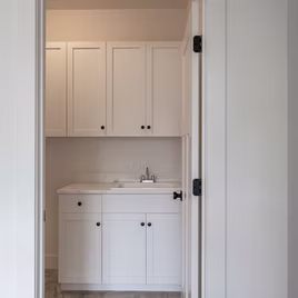 The Shaker Laundry Room from Lafata Cabinets uses maple wood with a white finish. Cabinets crafted in Michigan since 1958.