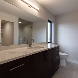 The Midwest bathroom from Lafata Cabinets uses maple wood with a rye finish. Cabinets crafted in Michigan since 1958.