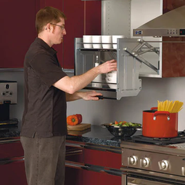 The Cabinet Pull-Down Shelving System by Lafata Cabinets. A pull-down shelving system is perfect for storing any type of kitchen tableware. This leaves the kitchen looking sleek and organized with a non-visible shelving system. Made in Michigan.