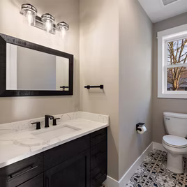 The New Shaker bathroom from Lafata Cabinets uses maple wood with a java finish. Cabinets crafted in Michigan since 1958.