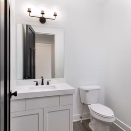 The New Shaker bathroom from Lafata Cabinets uses maple wood with a white finish. Cabinets crafted in Michigan since 1958.