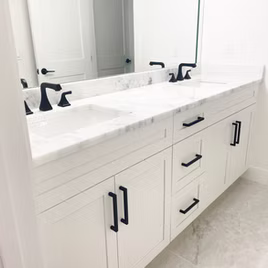 The New Shaker bathroom from Lafata Cabinets uses maple wood with a white finish. Cabinets crafted in Michigan since 1958.